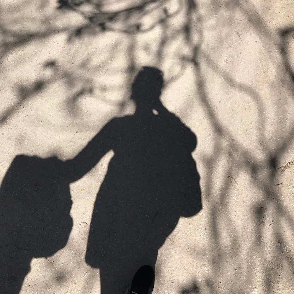 woman's full body shadow under tree